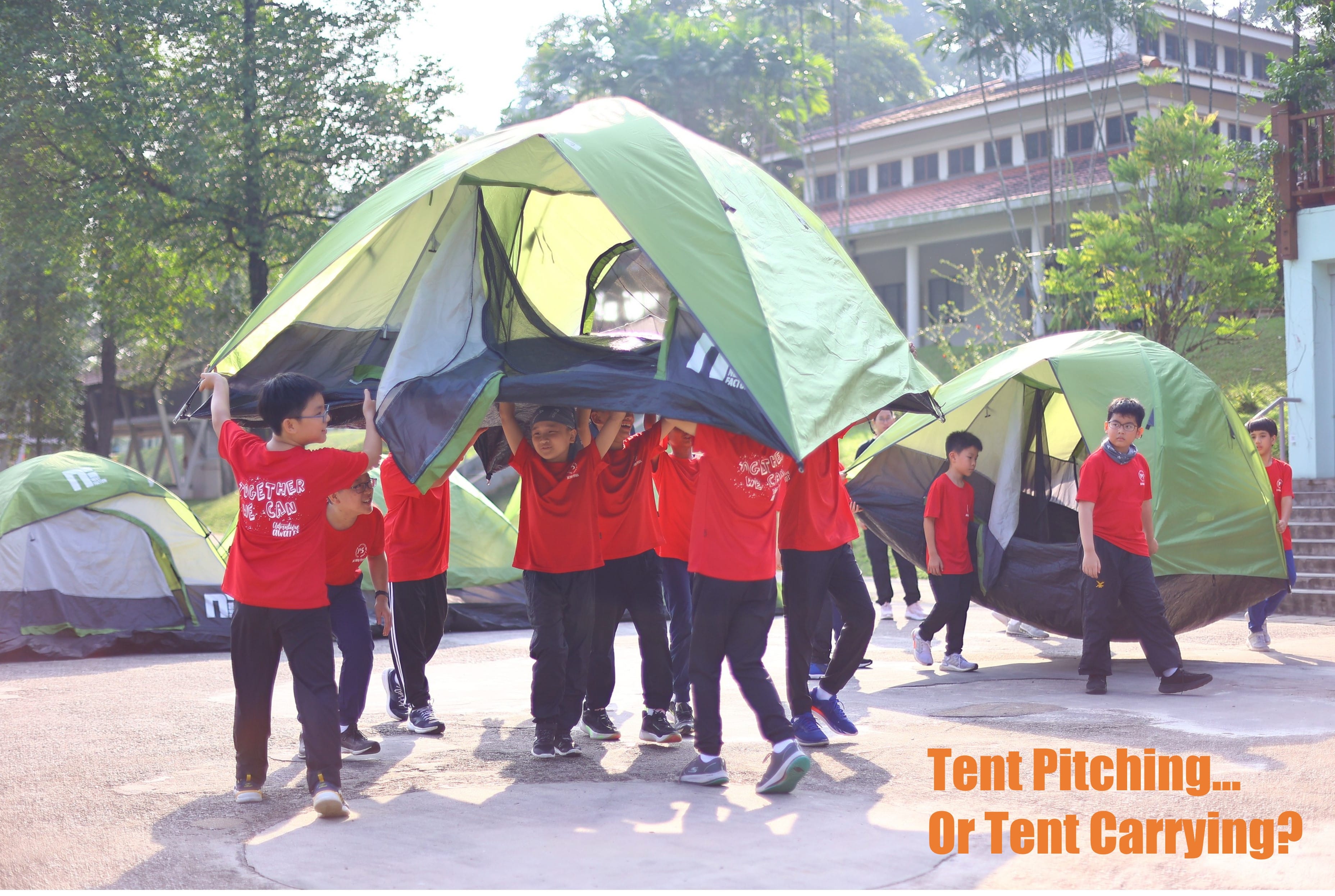 A group of P5 students carrying their tent